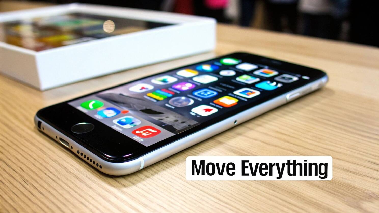 A person holding a new iPhone next to their old one, preparing to transfer data.